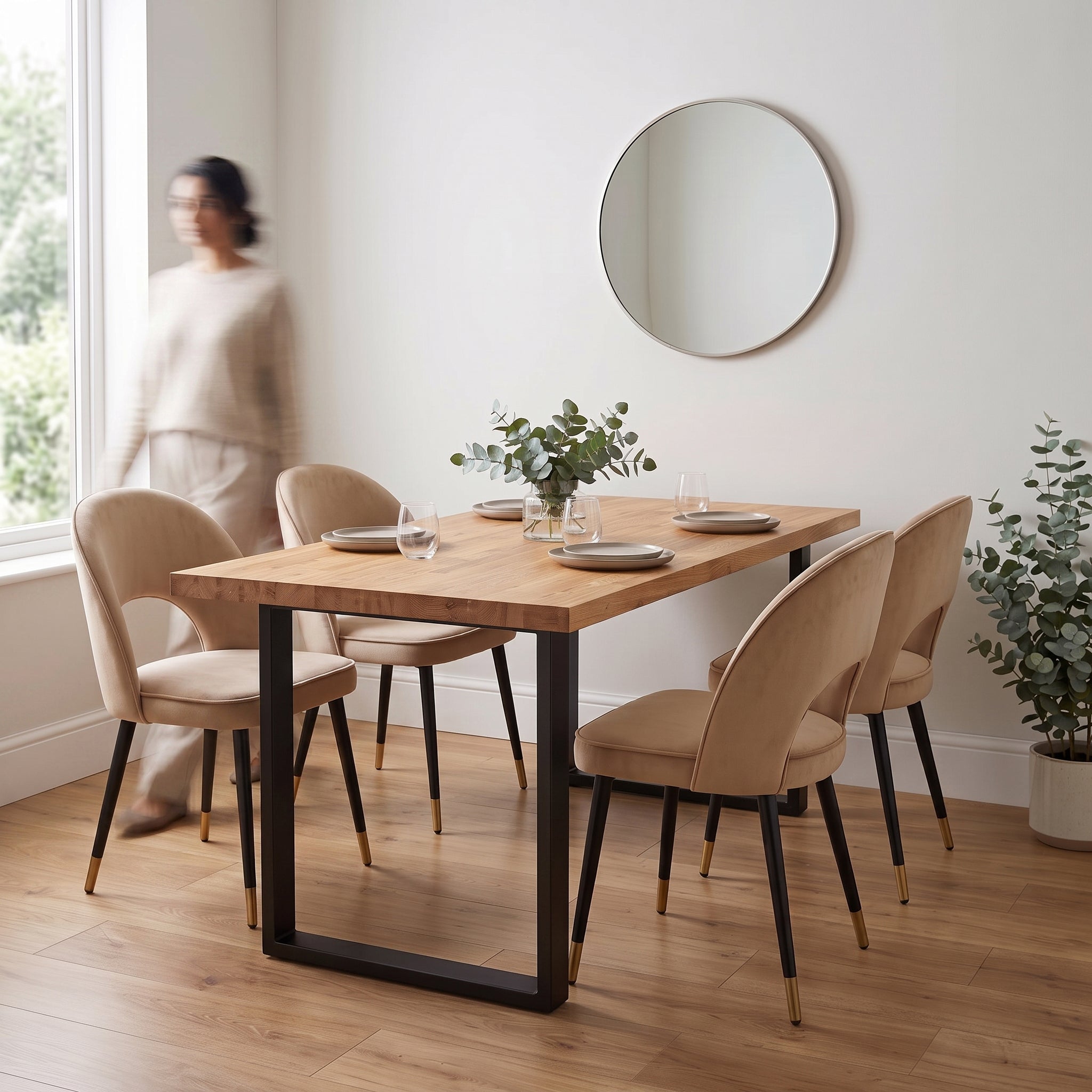 A rectangular dining table with an oak wood top and black metal base, surrounded by four upholstered beige chairs.