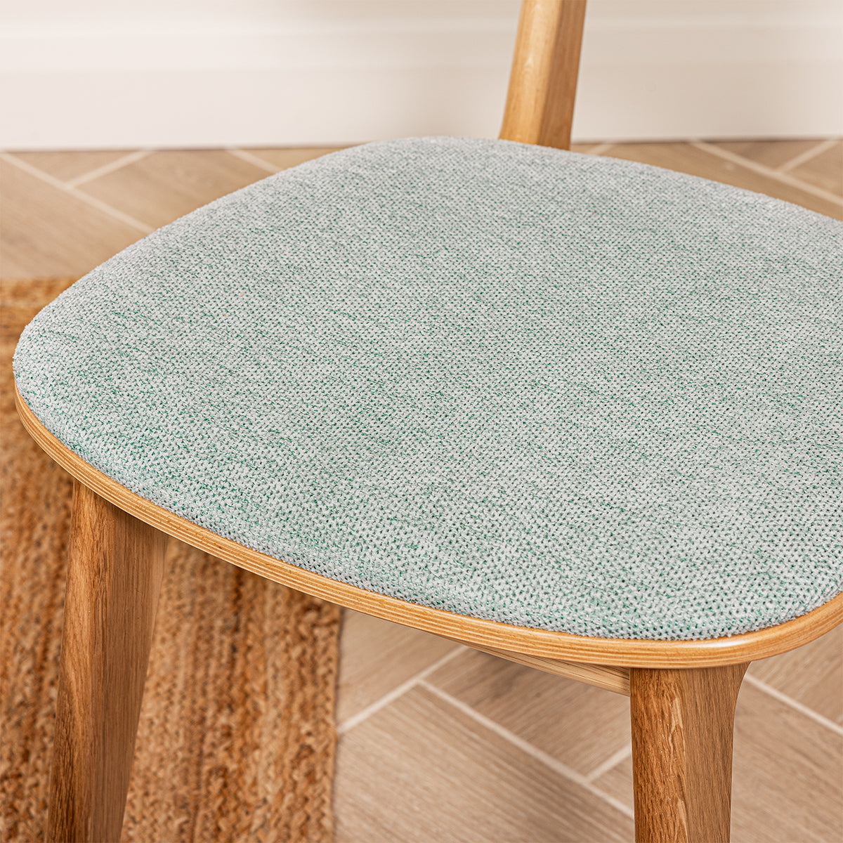 Close up of the Arden seat showing the sea green woven padded seat.