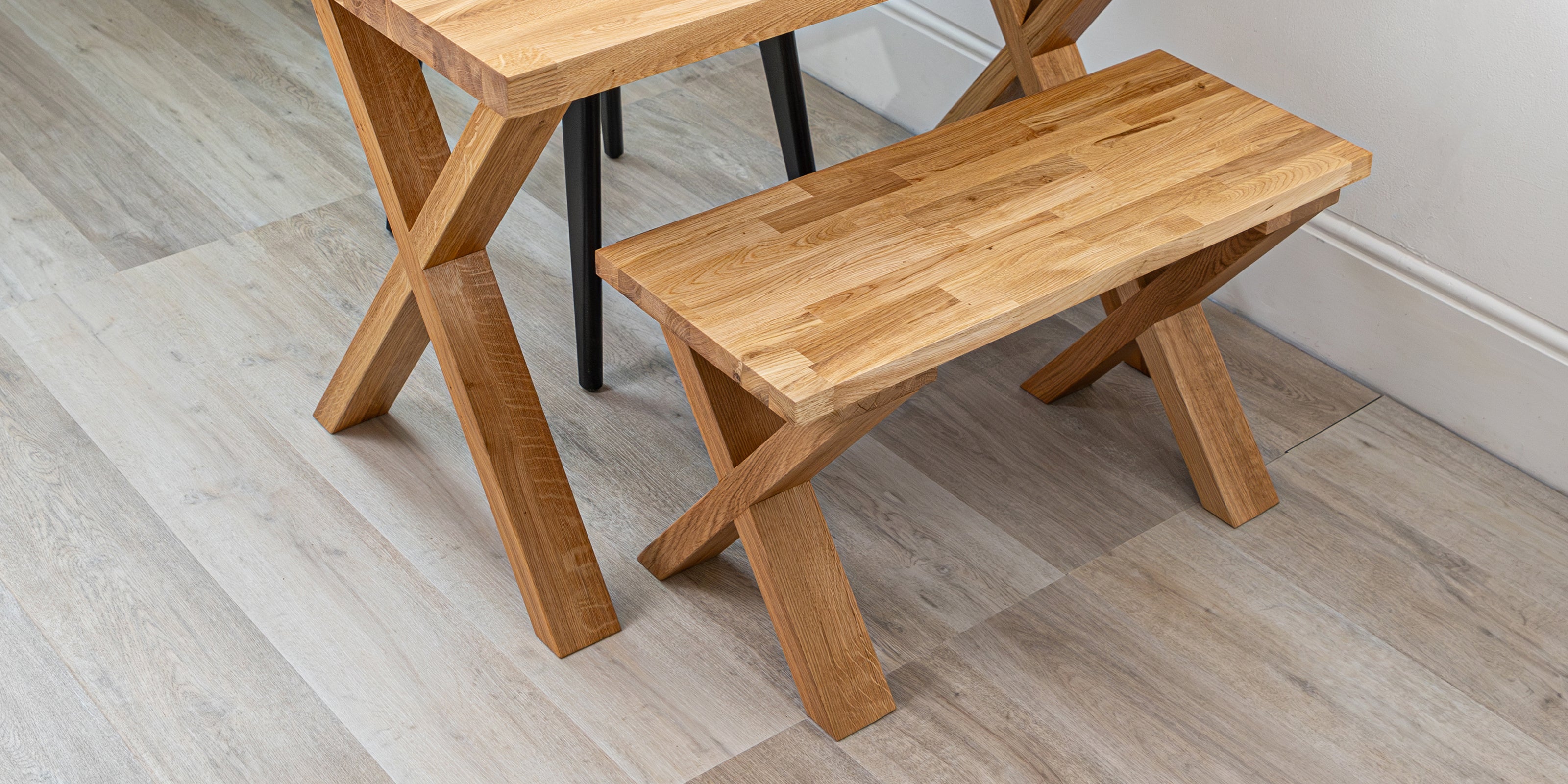 Solid oak bench with X legs, paired with a matching table.