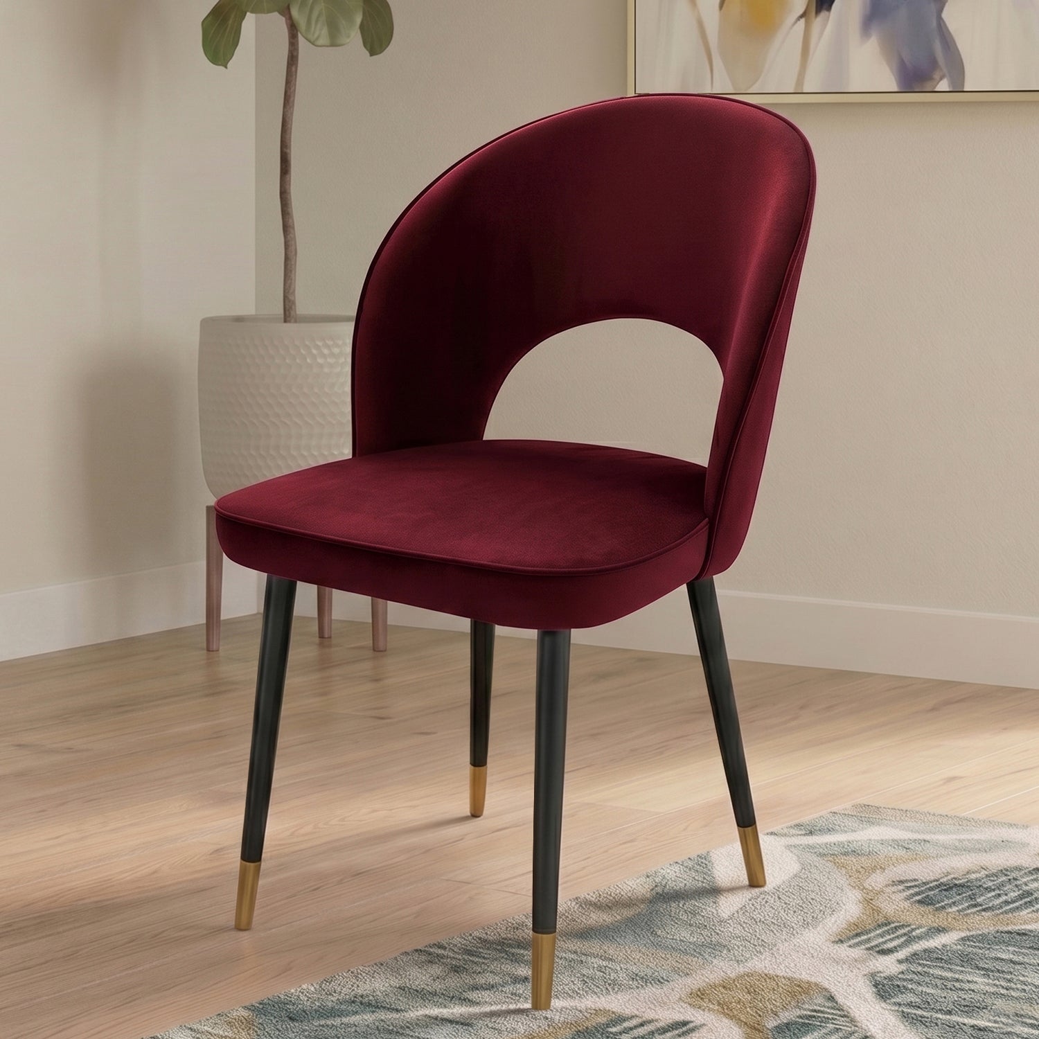A curved velvet dining chair with a calm, sculptural feel