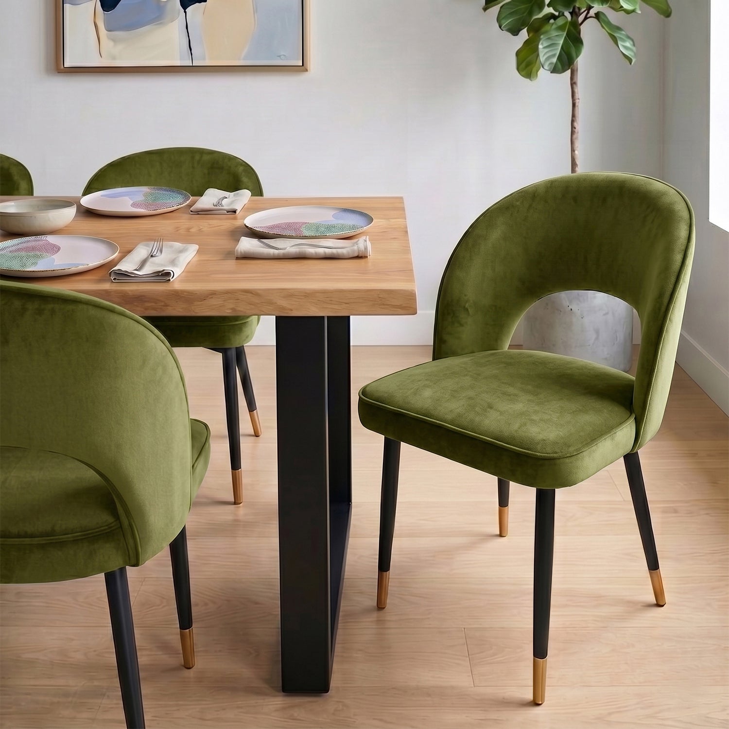 A curved velvet dining chair with a calm, sculptural feel