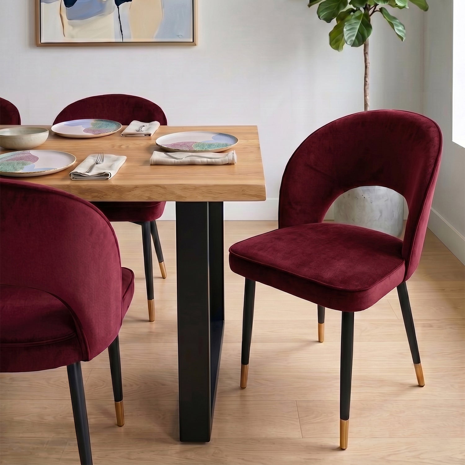 A curved velvet dining chair with a calm, sculptural feel
