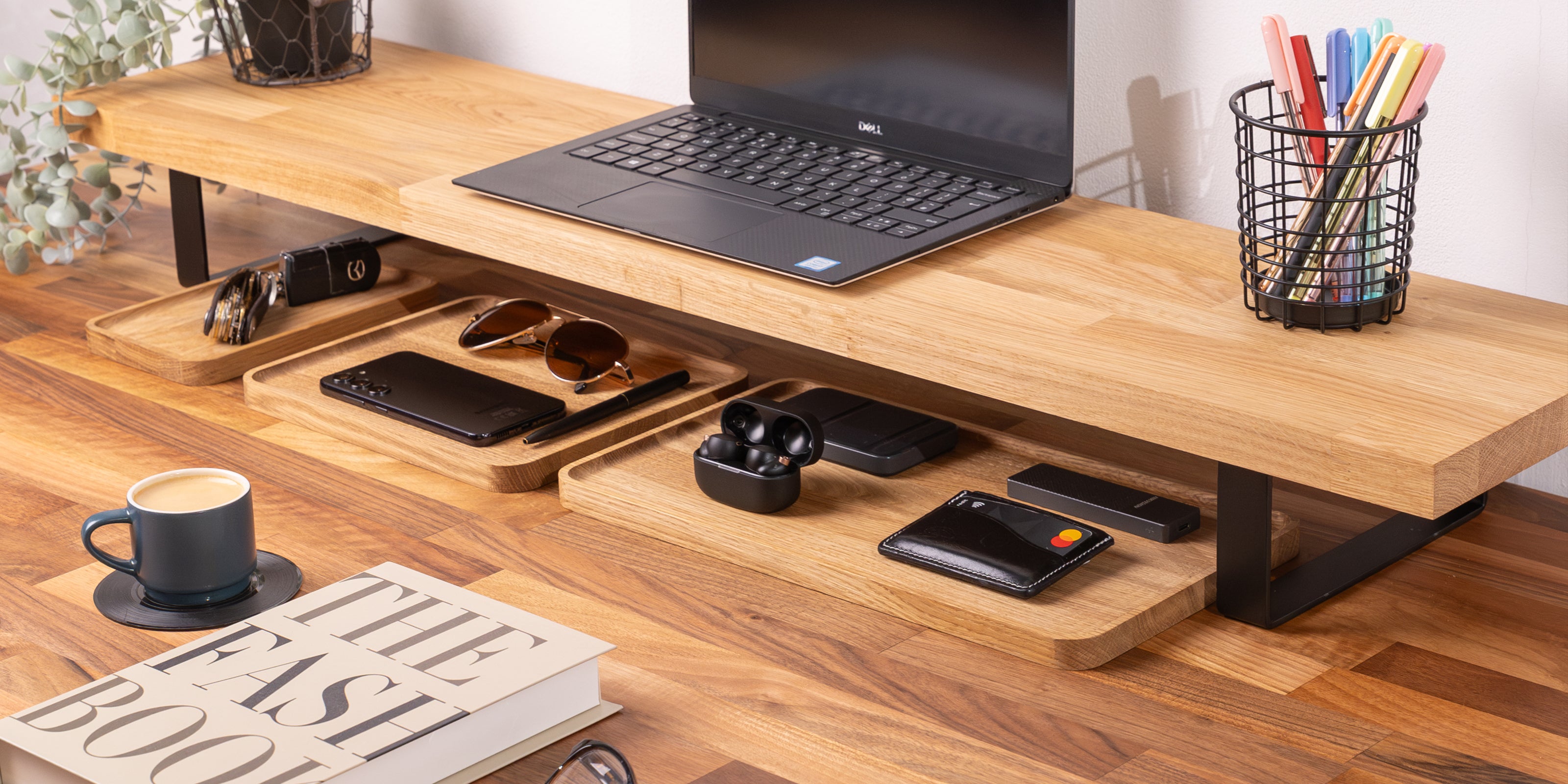 Solid oak monitor stand shown paired with a walnut desktop and oak desk organisers