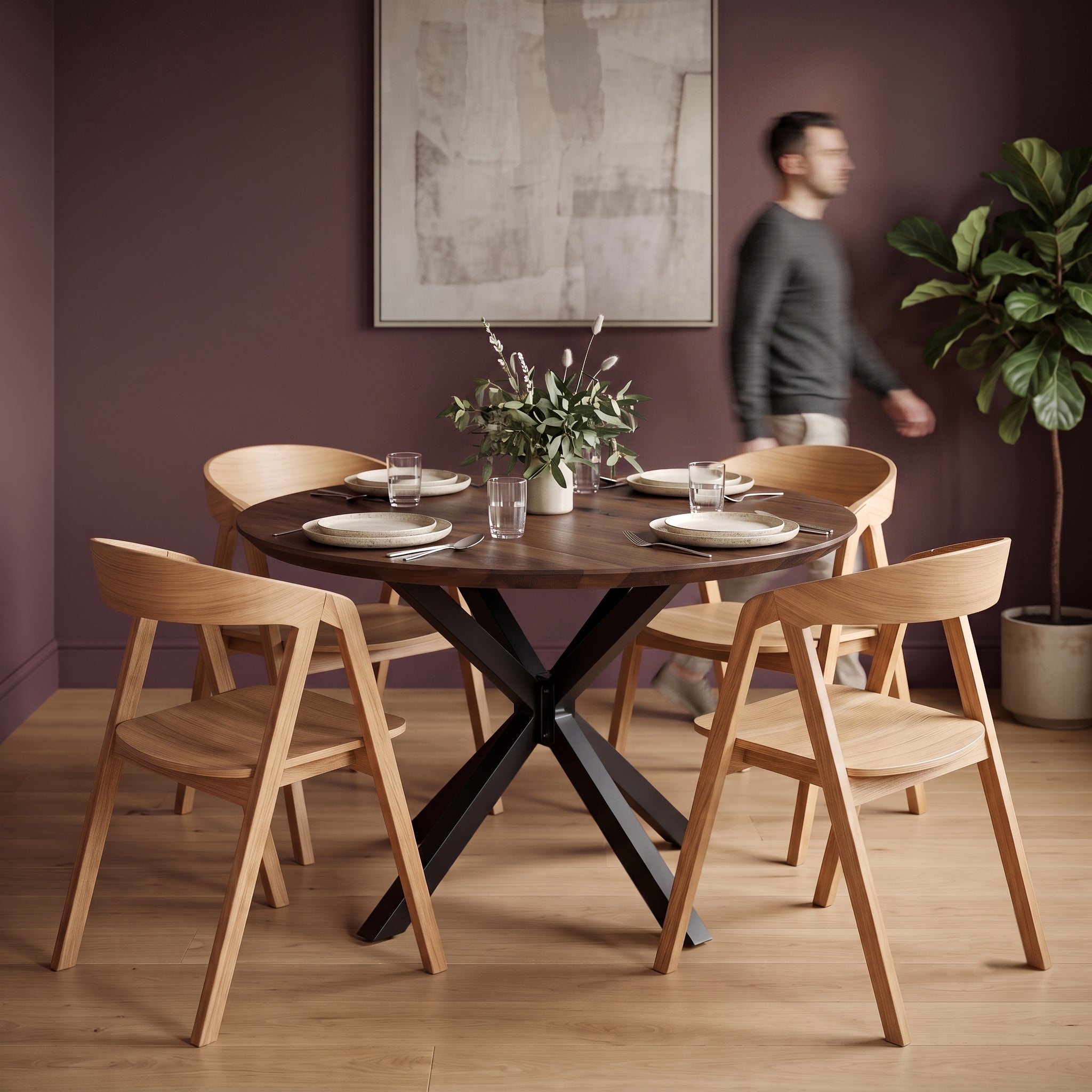 Premium dining space with a solid oak table in a deep charcoal finish and four oak chairs with a person walking through.