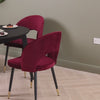 Video of a solid oak round extendable dining table finished in black, featuring 4 oxblood velvet dining chairs.