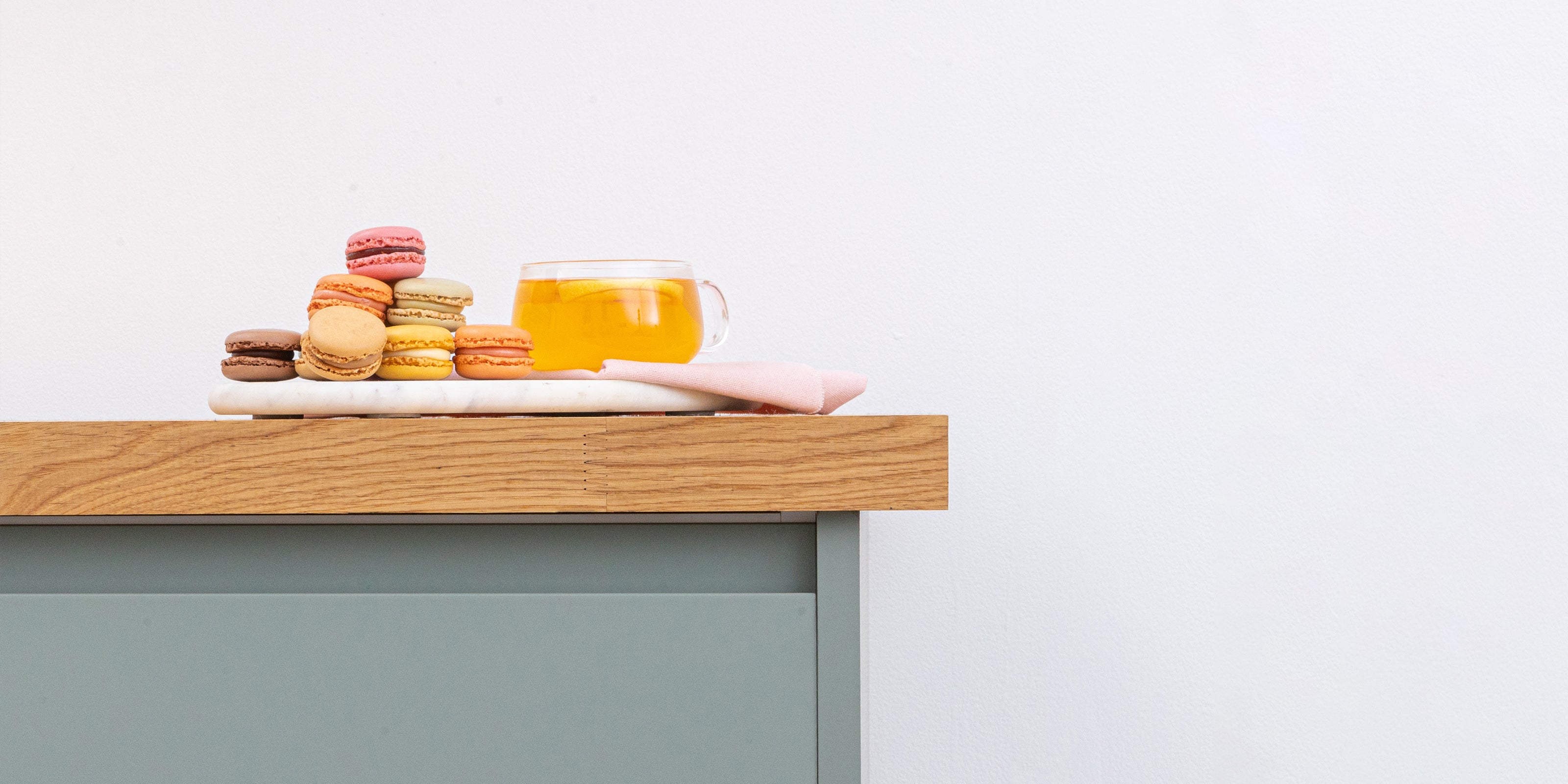 Prime oak solid wood worktop with macarons on a cabinet
