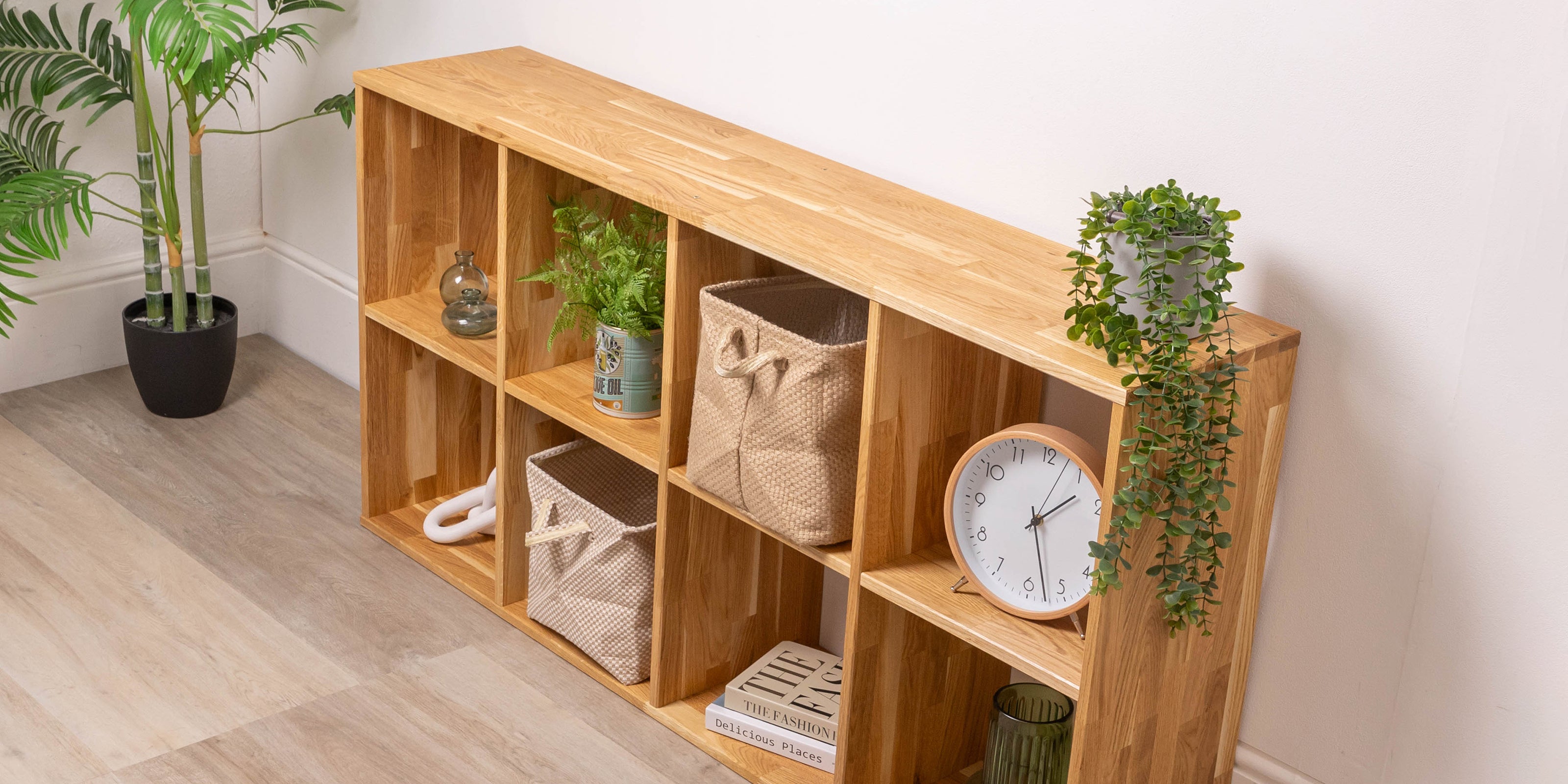Solid oak cube storage with plants and a clock in a room setting