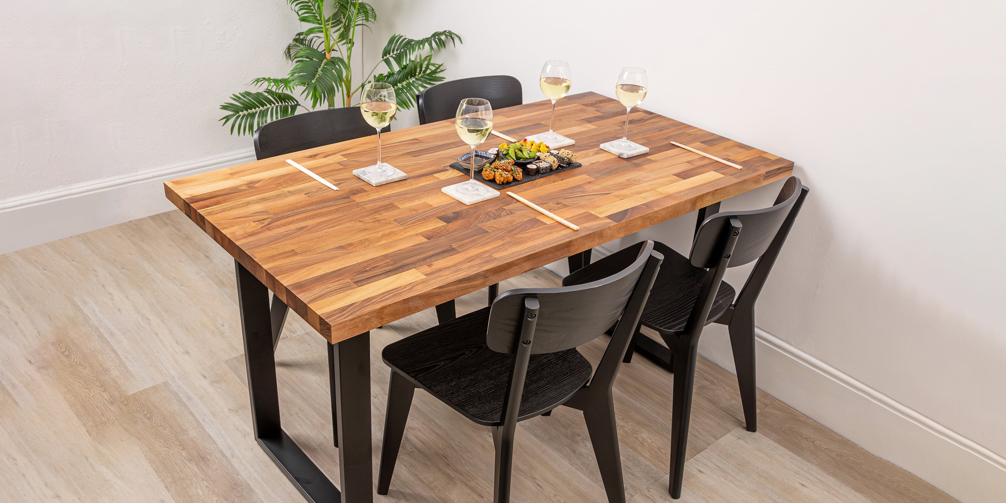 Walnut solid wood table with chairs and wine glasses.