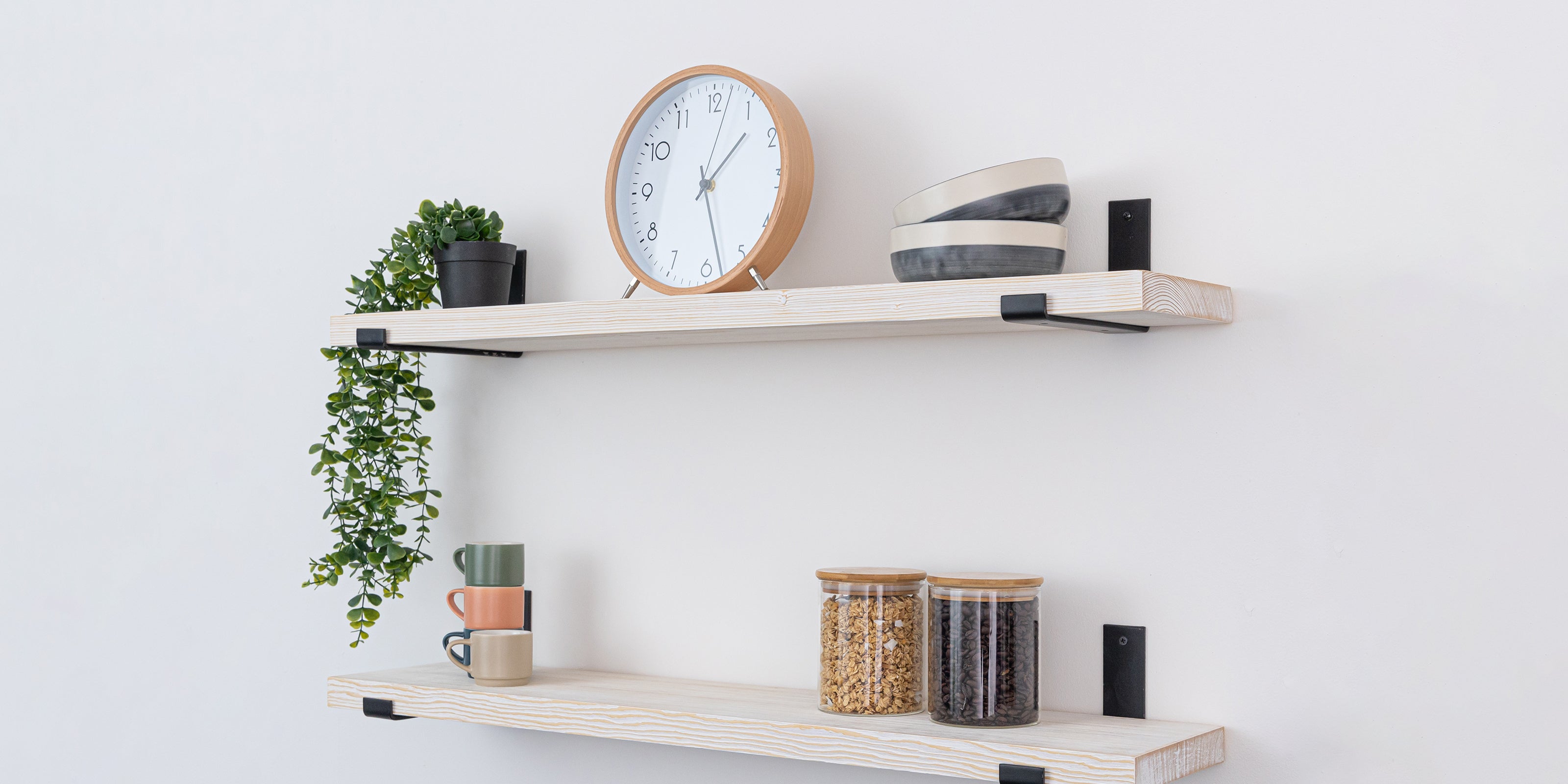 White shelves with decorative items and up-style black brackets.